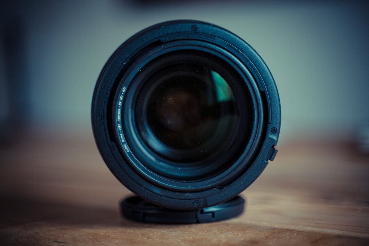 Black Camera Lens on Brown Wooden Table